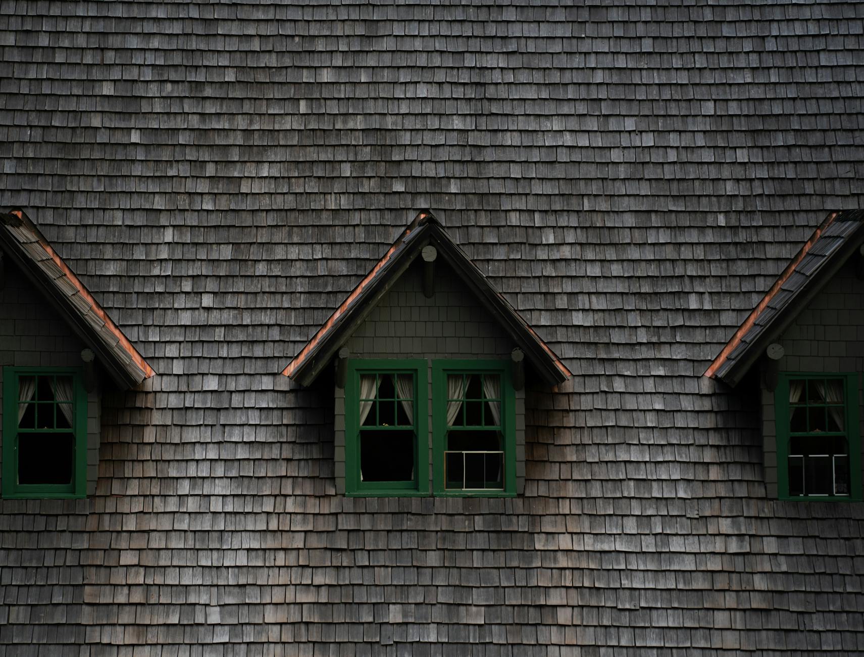 A close-up of newly installed architectural shingles with copper zinc strips to prevent moss growth on a Mt. Angel roof.