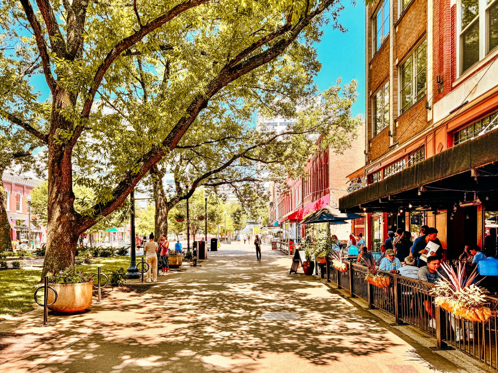 A scenic view of historic brick buildings along Third Street in downtown McMinnville, Oregon, during a clear autumn afternoon.